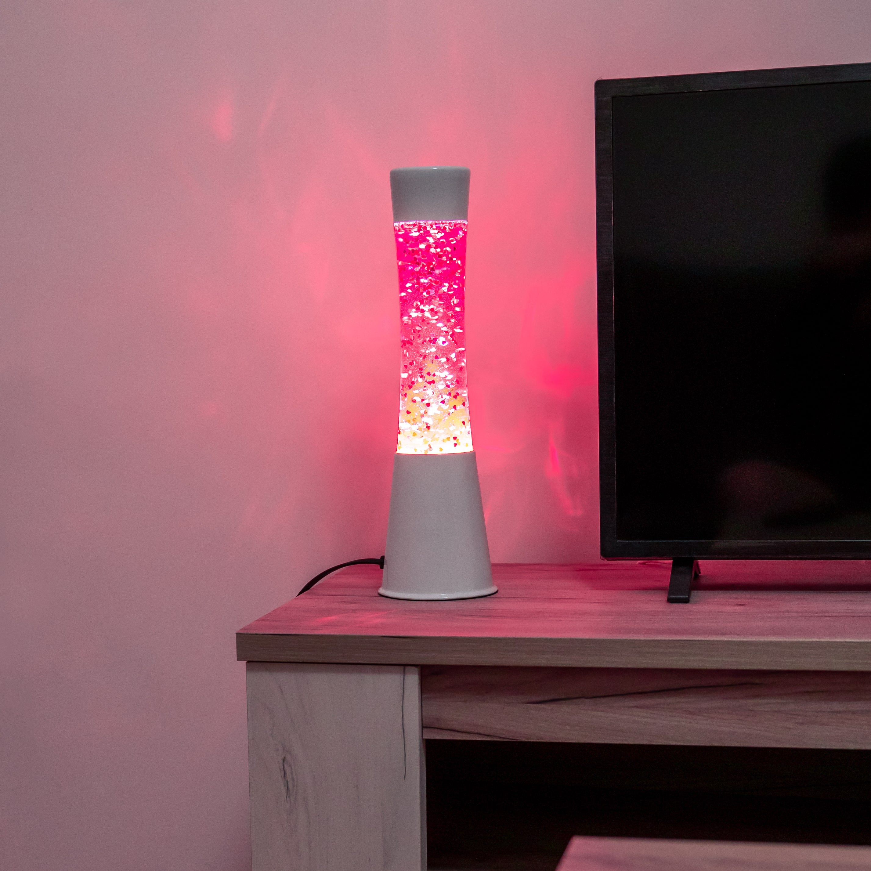Lámpara de lava con purpurina de corazones con base blanca y líquido rosa
