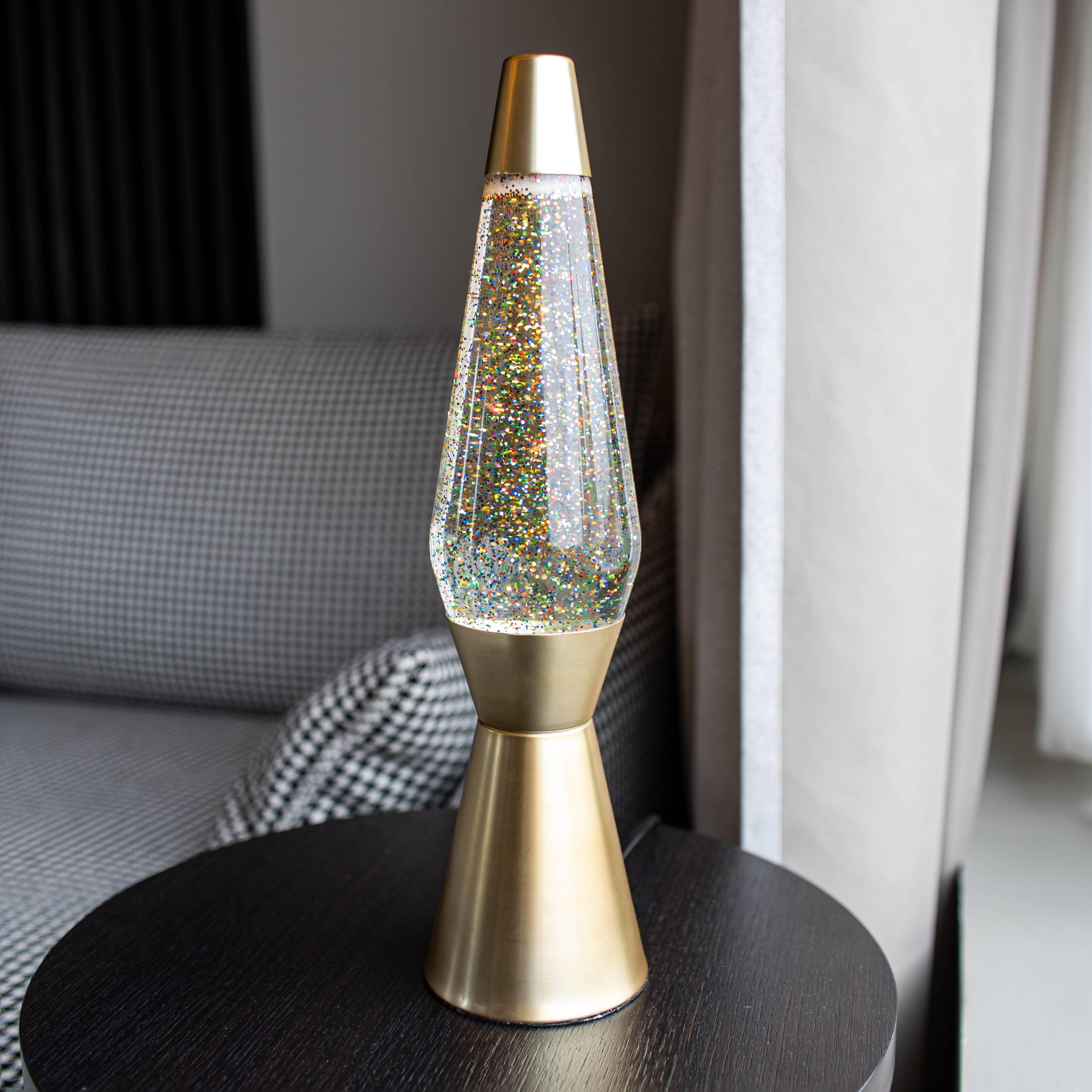 Lámpara de Lava 'Bullet' con base oro mate, líquido transparente y lava purpurina oro
