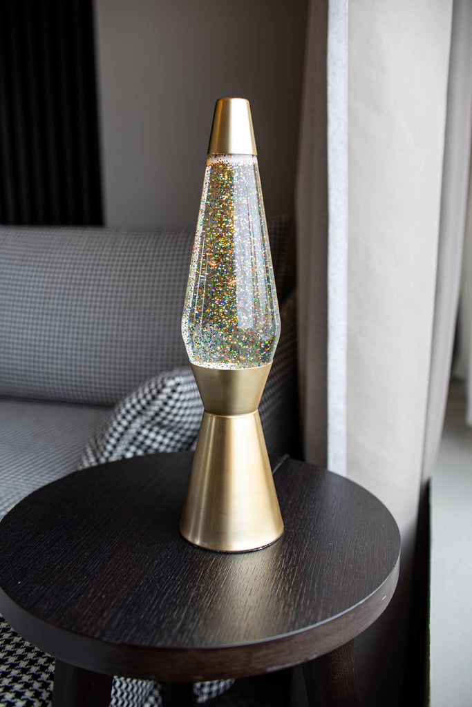 Lámpara de Lava 'Bullet' con base oro mate, líquido transparente y lava purpurina oro